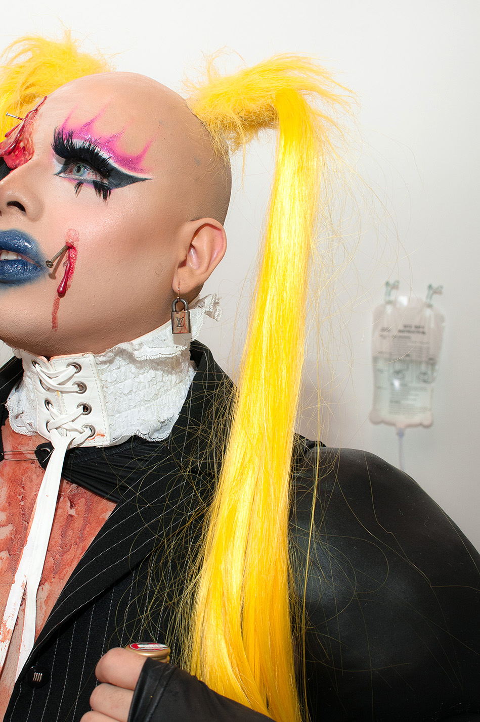 Detail of JPEG papi's long blonde braids and bloody facial prosthetics